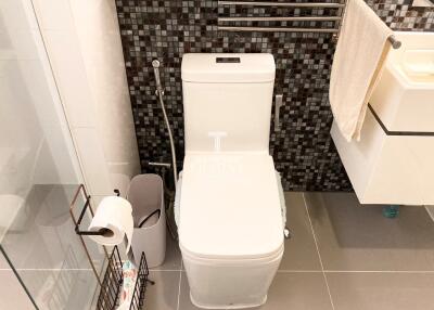 Modern bathroom with toilet, sink, and shower