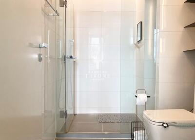 Modern bathroom with glass shower and tiled walls