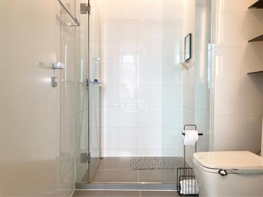 Modern bathroom with glass shower and tiled walls