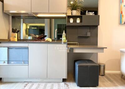 Modern kitchen with built-in appliances and a small desk area