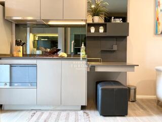 Modern kitchen with built-in appliances and a small desk area