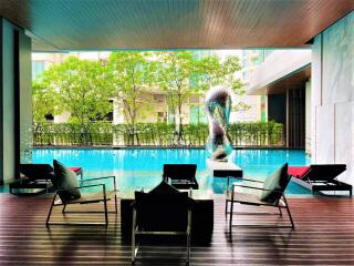 Modern outdoor pool area with lounge chairs