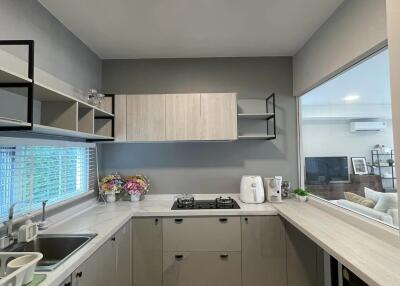 Modern kitchen with grey cabinets, white countertops and appliances