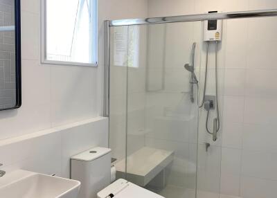 Modern bathroom with glass shower and white fixtures