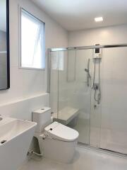 Modern bathroom with glass shower and white fixtures