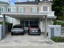 Two-story house with carport and two cars