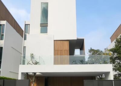 Modern three-story building with a minimalist design and large front garage