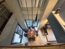 Bird's eye view of a modern dining area with a wooden table and six chairs