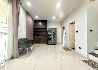 Modern living room with kitchenette and glass door