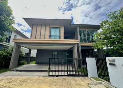 Two-story house with a gated driveway and front yard