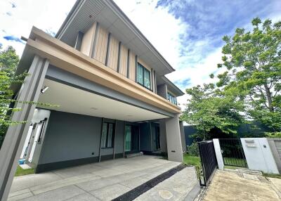 Modern two-story house with a garage and front yard