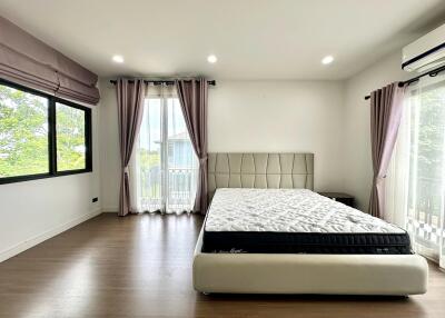 Spacious bedroom with large windows and natural light