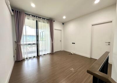 Living room with large windows and wooden floor