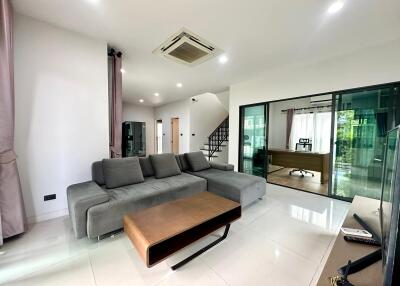 Spacious modern living room with a view of the study