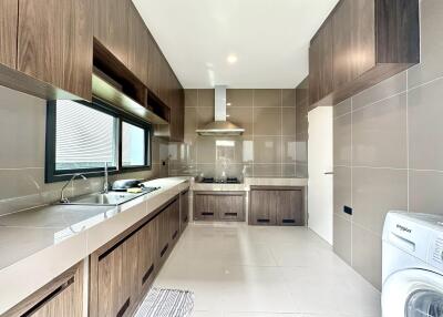 Modern kitchen with wooden cabinetry and stainless steel appliances