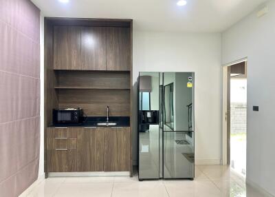 Modern kitchen with built-in wooden cabinetry and appliances