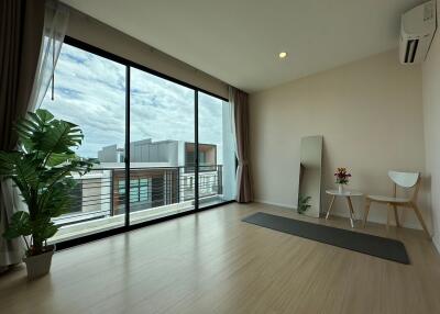 Minimalistic room with large windows and balcony view