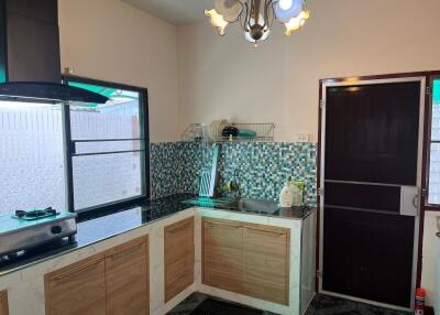 Modern kitchen with tiled backsplash and ample storage