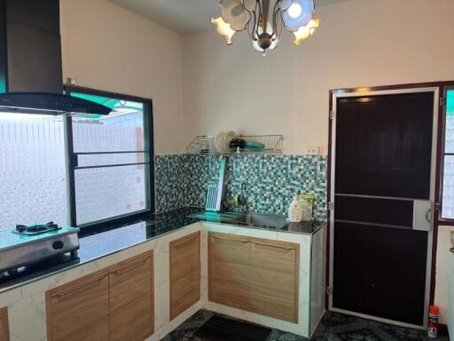 Modern kitchen with tiled backsplash and ample storage