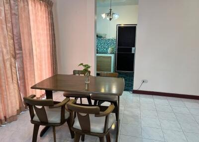 Dining space with table and chairs near a partition