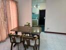 Dining space with table and chairs near a partition