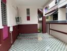 Covered balcony area with patterned floor tiles and air conditioning unit