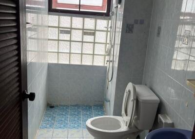 Bathroom with toilet, sink, and shower