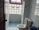 Bathroom with toilet, sink, and shower