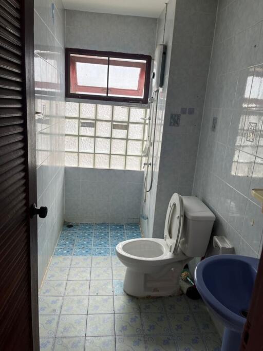 Bathroom with toilet, sink, and shower