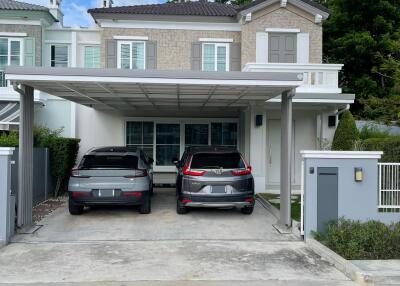 Front view of a modern two-story house with garage and driveway.