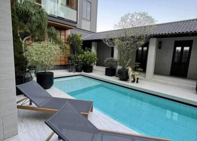 Modern outdoor area with a swimming pool and loungers