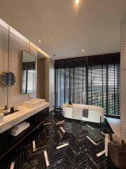 Modern bathroom with large windows, freestanding bathtub, and stylish decor