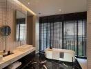 Modern bathroom with large windows, freestanding bathtub, and stylish decor