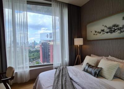 Modern bedroom with large window and city view