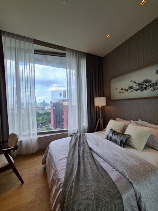 Modern bedroom with large window and city view