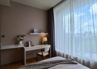 Modern bedroom with large window and desk