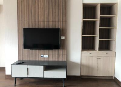 Modern living space with TV wall mount and built-in shelves