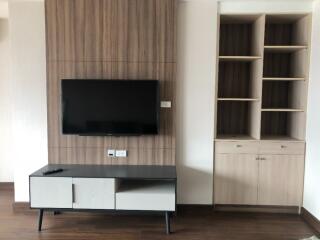 Modern living space with TV wall mount and built-in shelves