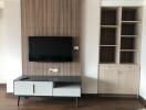 Modern living space with TV wall mount and built-in shelves