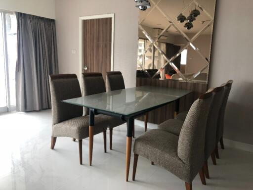 Modern dining room with glass table and six chairs