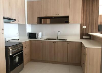 Modern kitchen with wooden cabinets and stainless steel appliances