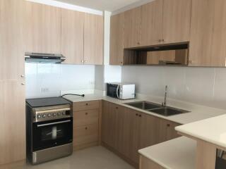 Modern kitchen with wooden cabinets and appliances