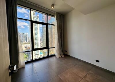 Bedroom with large window and city view