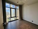 Bedroom with large window and city view