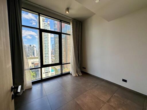 Bedroom with large window and city view