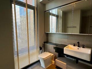 Modern bathroom with large window, blinds, and a floating sink