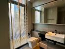 Modern bathroom with large window, blinds, and a floating sink