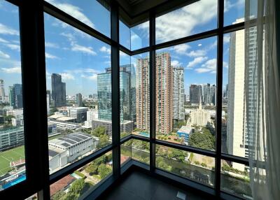 Cityscape view from a high-rise building with large windows