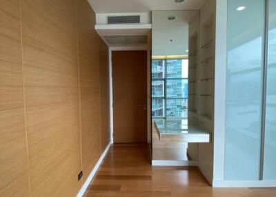 Modern hallway area with wooden floor and built-in desk