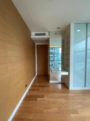 Modern hallway area with wooden floor and built-in desk